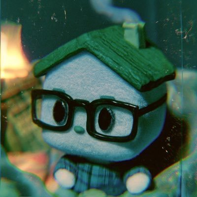 The original Ozzification character: a felt house with a green roof and thick black glasses